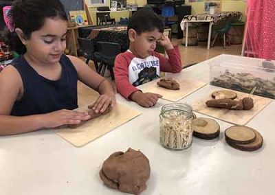 An image of two kids playing with clay in the best day care centre in Carlingford.