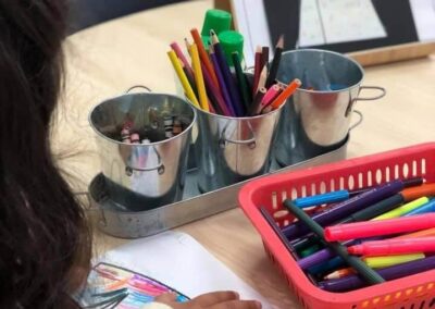 An image of children learning how to draw and paint in early learning childcare centre.