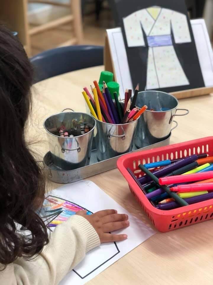 An image of children learning how to draw and paint in early learning childcare centre.