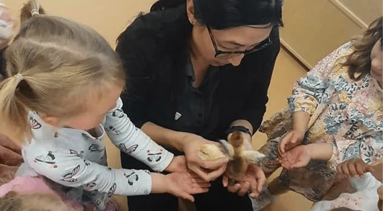 An image of teacher performing an education leader role in a childcare centre and educating children.